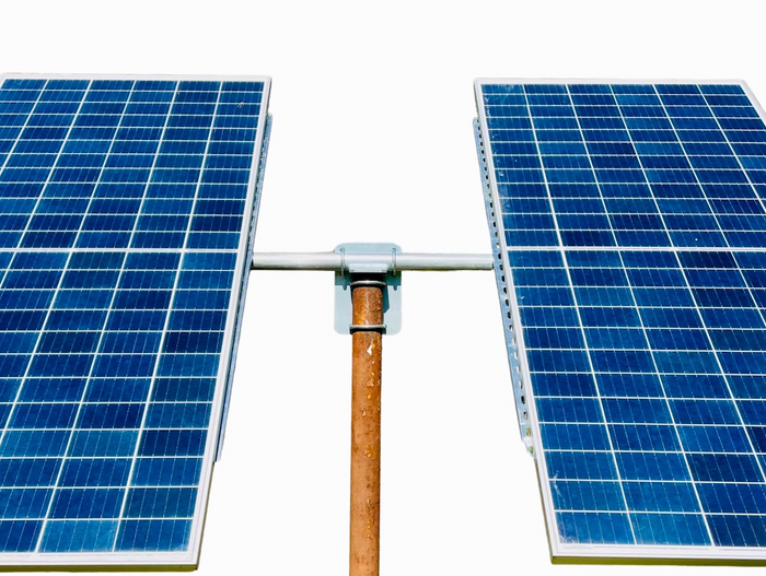 Two solar panels mounted on a single pole with a top of pole mount